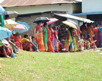 2019 South Dinajpur: Voters use umbrellas to shield themselves from the scorching sun as they wait in a queue to cast their votes for the third phase of 2019 Lok Sabha elections, at a polling station in West Bengal